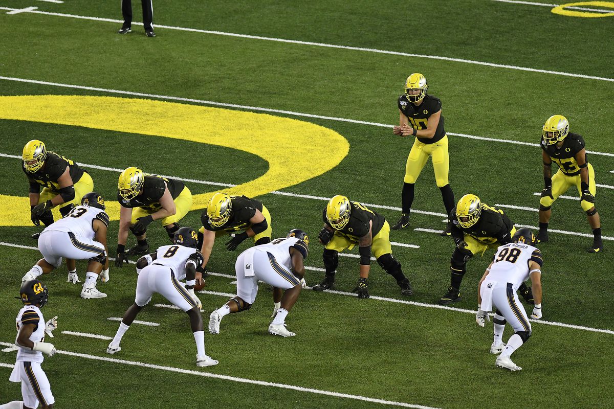 Oregon’s beefy offensive line sets to protect him against the California Golden Bears, Oct. 5, 2019.