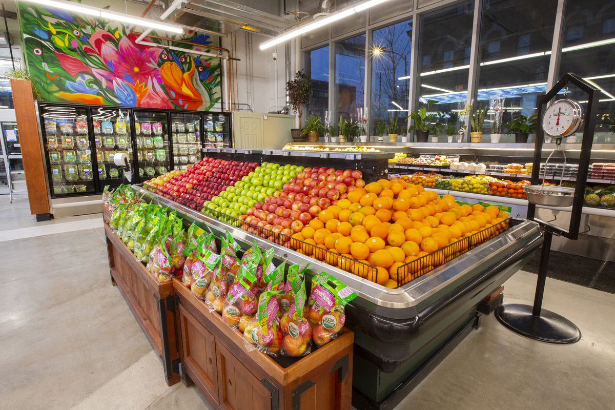 A grocery store section filled with fresh fruit.