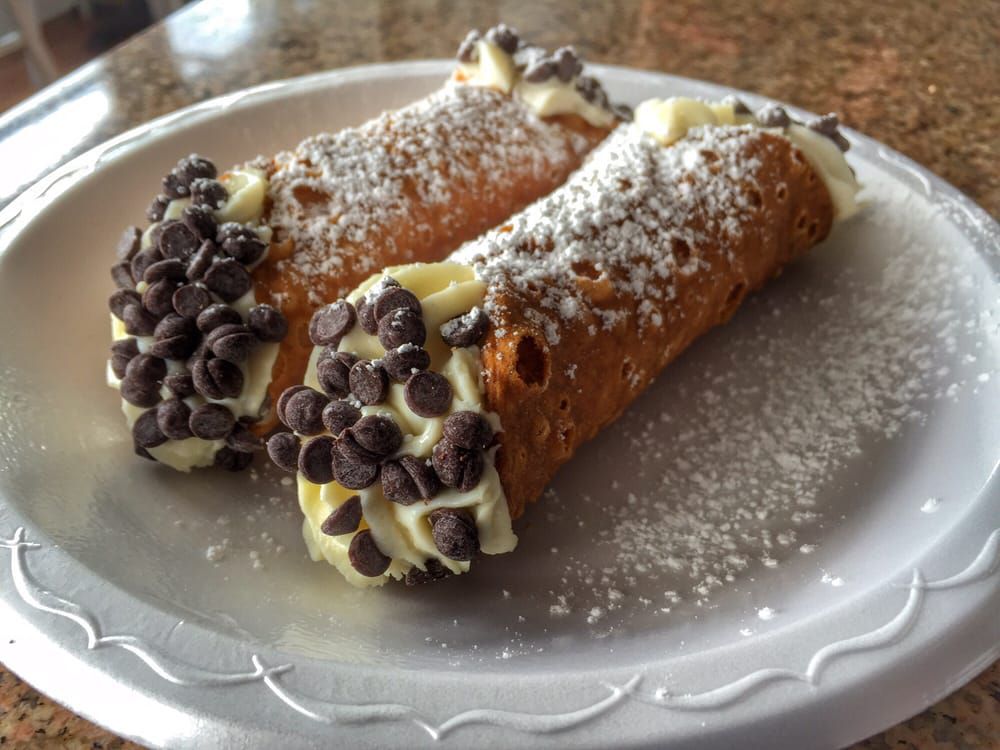 Two chocolate chip cannolis on a white plate from E. 48th Street Market in Dunwoody, GA. 