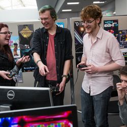 Kimmy Workman, Kyler Alvey, Kaleb Elmer and S. Brian Zavala, left to right, play a game at the EAE Play! showcase of games created by the Entertainment Arts & Engineering video game development program at the University of Utah in Salt Lake City on Friday, Dec. 9, 2016.