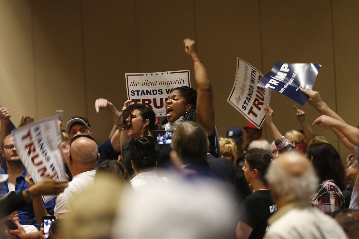 Protesters are removed from the Tampa Convention Center as Republican presidential candidate Donald Trump speaks to supporters during a town hall meeting on March 14, 2016, at in Tampa, Florida.