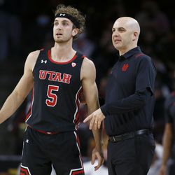 Utah coach Craig Smith talks with guard Jaxon Brenchley during the first half of the team’s NCAA college basketball game against Southern California in Los Angeles, Wednesday, Dec. 1, 2021. 