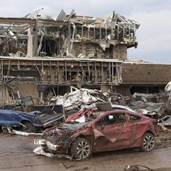 The Moore Medical Center and vehicles lay damaged after a tornado moves through Moore, Okla. on Monday, May 20, 2013.