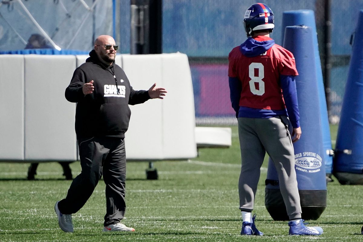 New York Giants head coach Brian Daboll and quarterback Daniel Jones (8) talk during voluntary minicamp at the Quest Diagnostics Training Center in East Rutherford