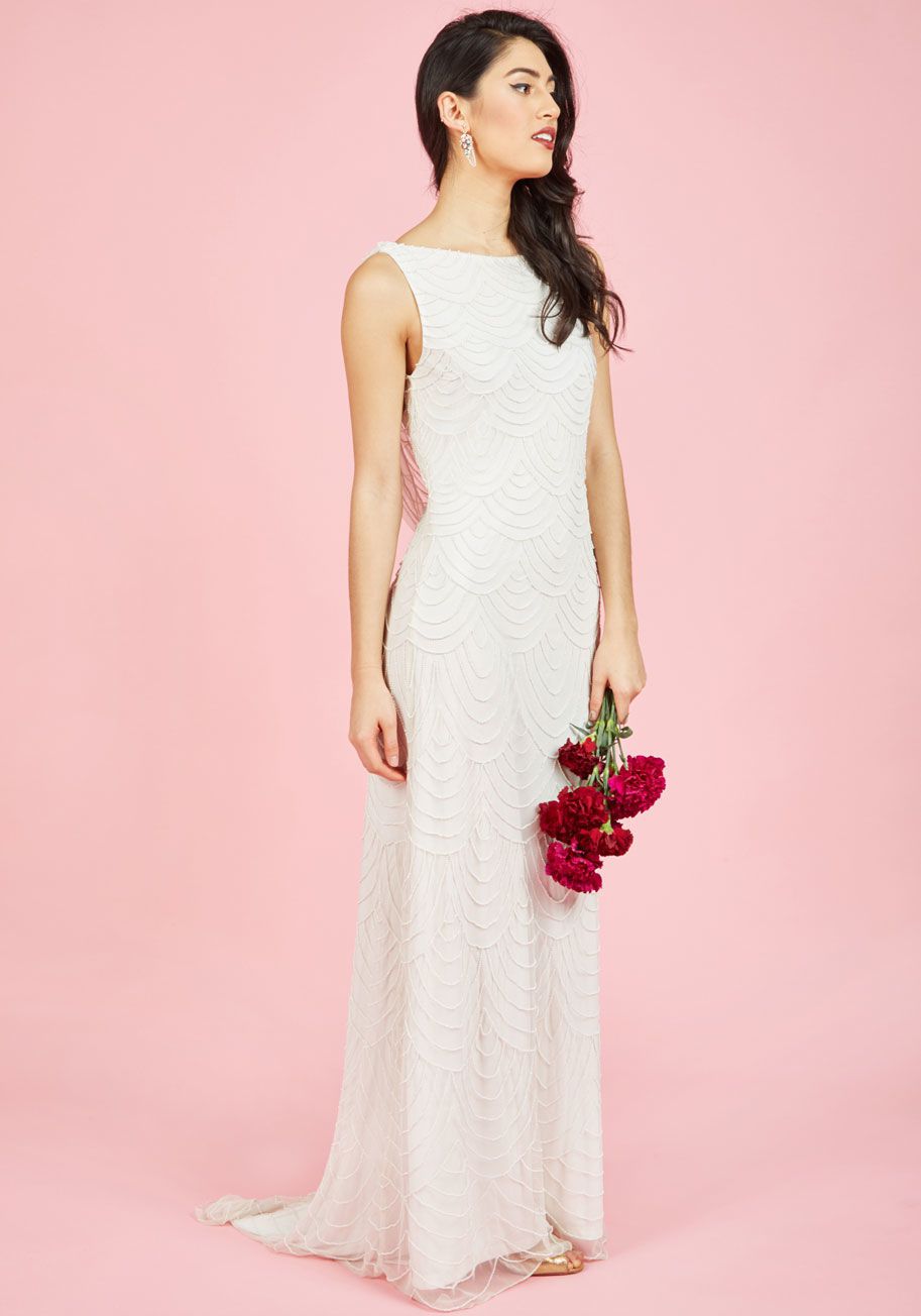 Model in wedding dress on pink background.
