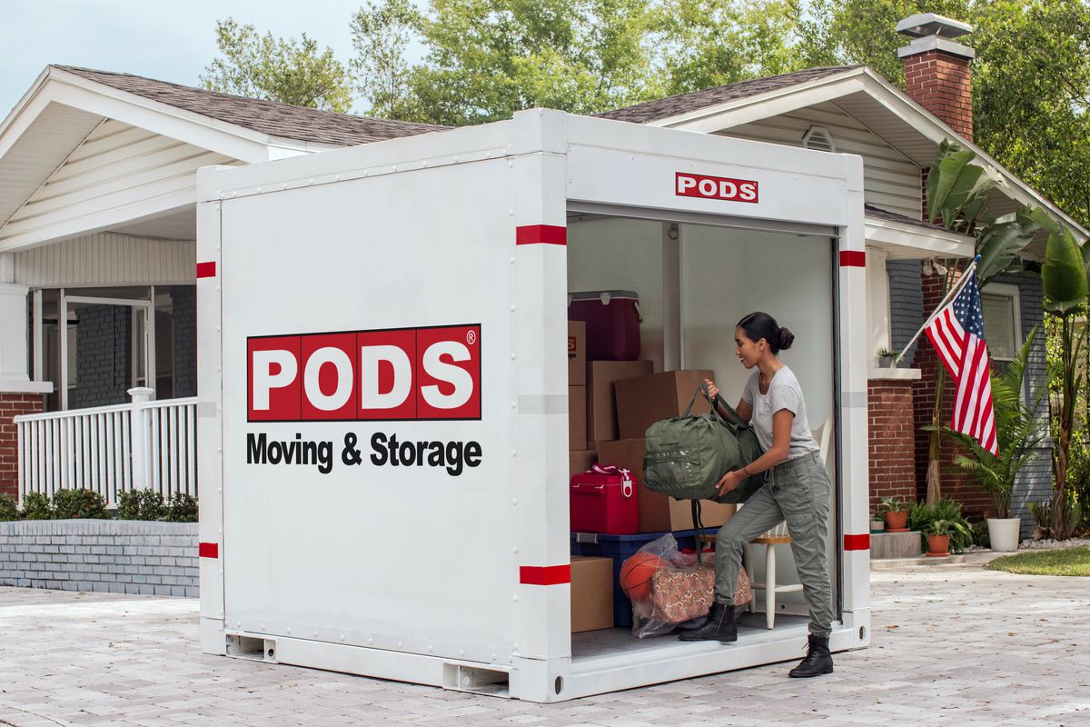 Woman loading belongings into PODS container
