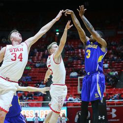 Utah Utes forward Jayce Johnson (34) and Utah Utes guard Parker Van Dyke (5) try to defend a 3-point shot by UC Riverside Highlanders guard Chance Murray (3) as Utah and UC Riverside play at the Huntsman Center in Salt Lake City on Friday, Nov. 25, 2016.