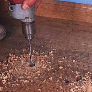Man Uses Sharp Spade Bit To Bore Through End Of Every Floorboard