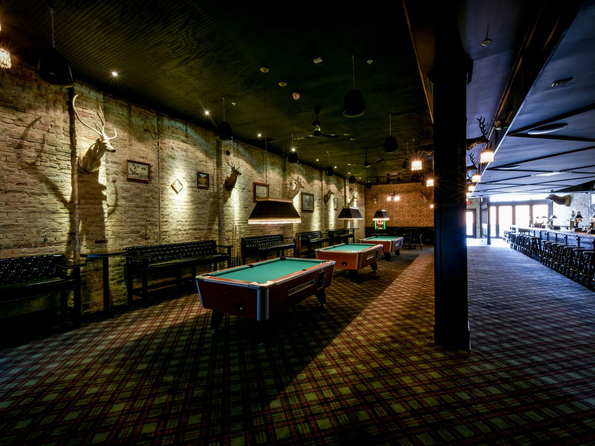A bar space with pool tables.