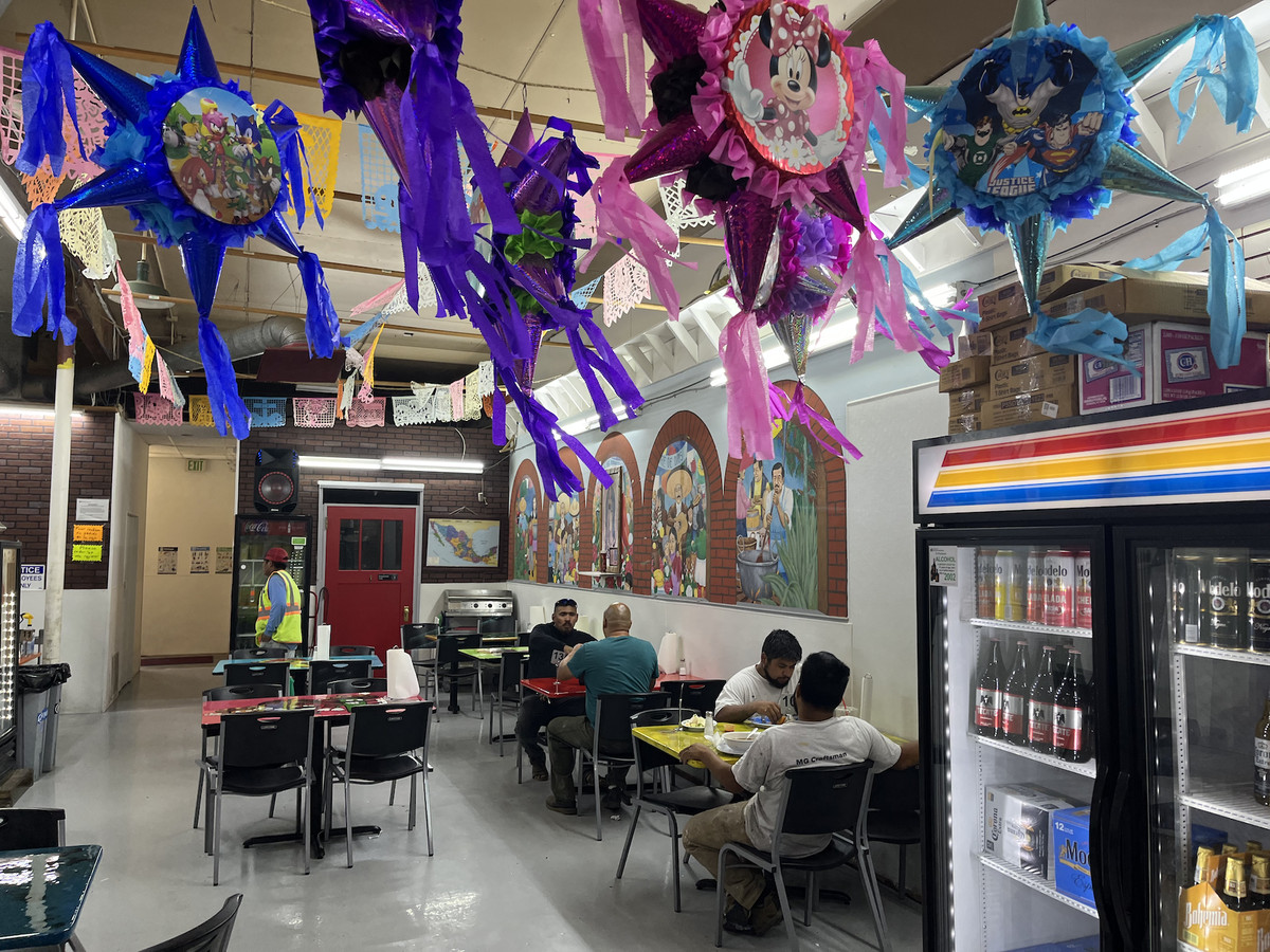 A dining room with pinatas hanging over it.