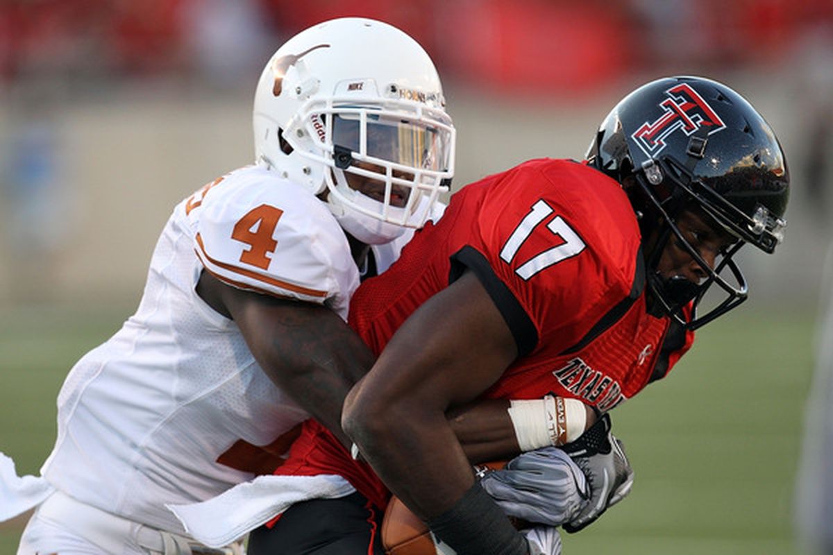 LUBBOCK TX - SEPTEMBER 18:  Detron Lewis #17 of the Texas Tech Red Raiders makes a pass reception against Aaron Williams #4 of the Texas Longhorns at Jones AT&T Stadium on September 18 2010 in Lubbock Texas.  (Photo by Ronald Martinez/Getty Images)