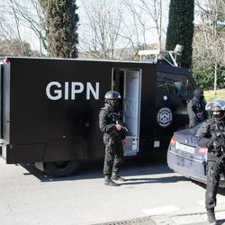 Elite police officers block the entrance of the Castellane housing project of Marseille, southern France, Monday, Feb.9, 2015. Police say gunmen have fired automatic weapons at the edge of a housing project the same day as the prime minister planned to visit the city. The project is rife with drug gangs and violence. No injuries were immediately reported. 