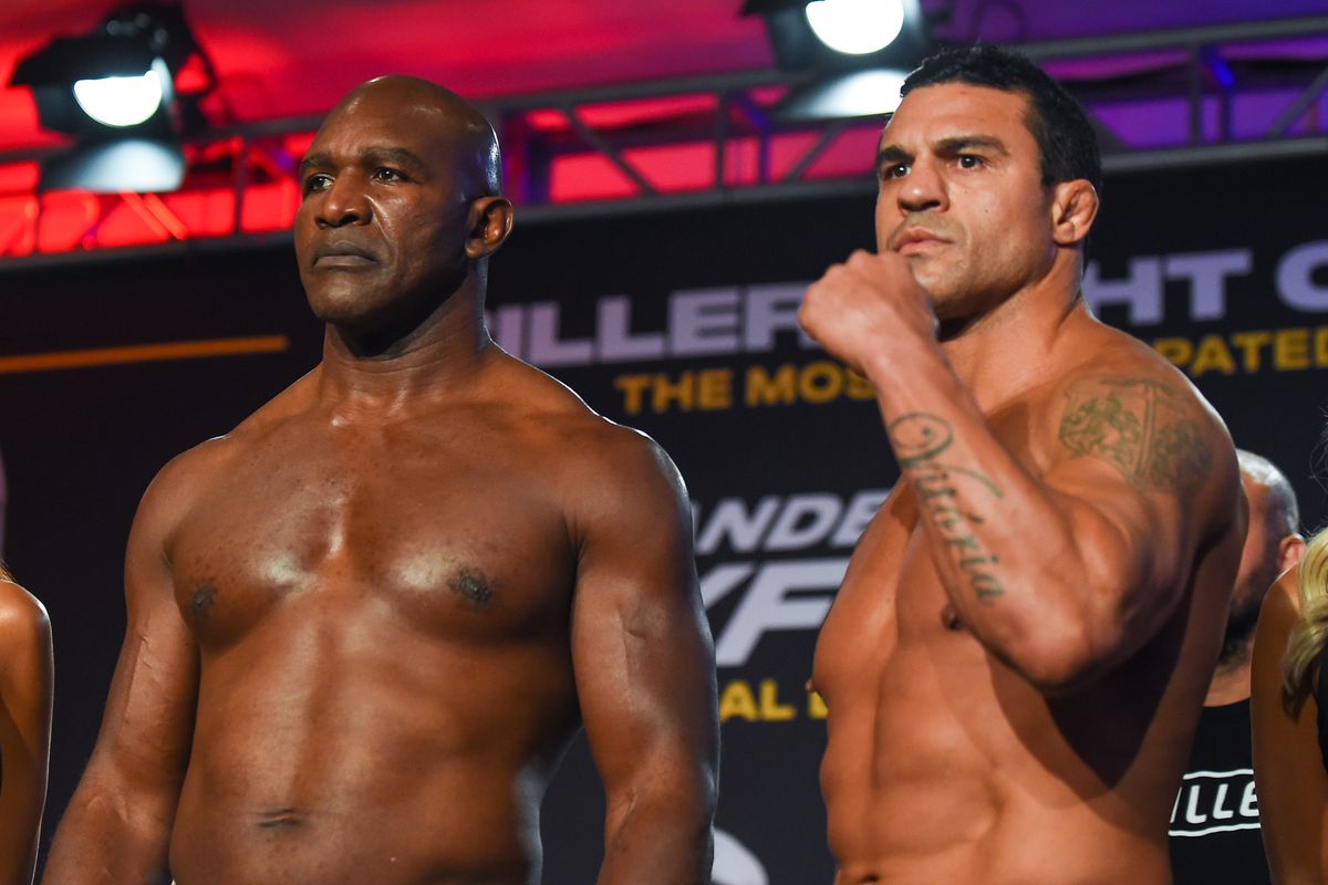 Holyfield and Belfort pose for the media during weigh-ins for their upcoming PPV bout.