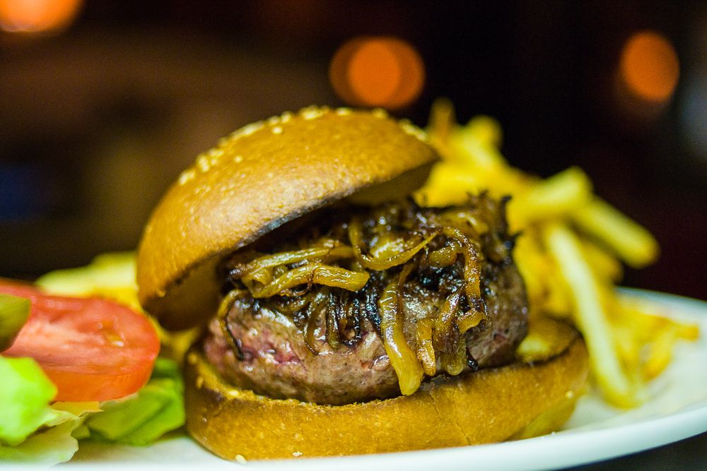 The Minetta Tavern burger, called “The Black Label” is just beef, onions, and bun on a plate