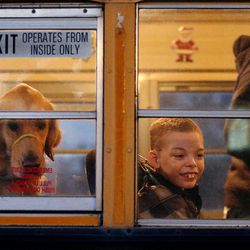 Britton and his service dog, Dopey, leave for school in Clearfield on Monday, Dec. 19, 2016.