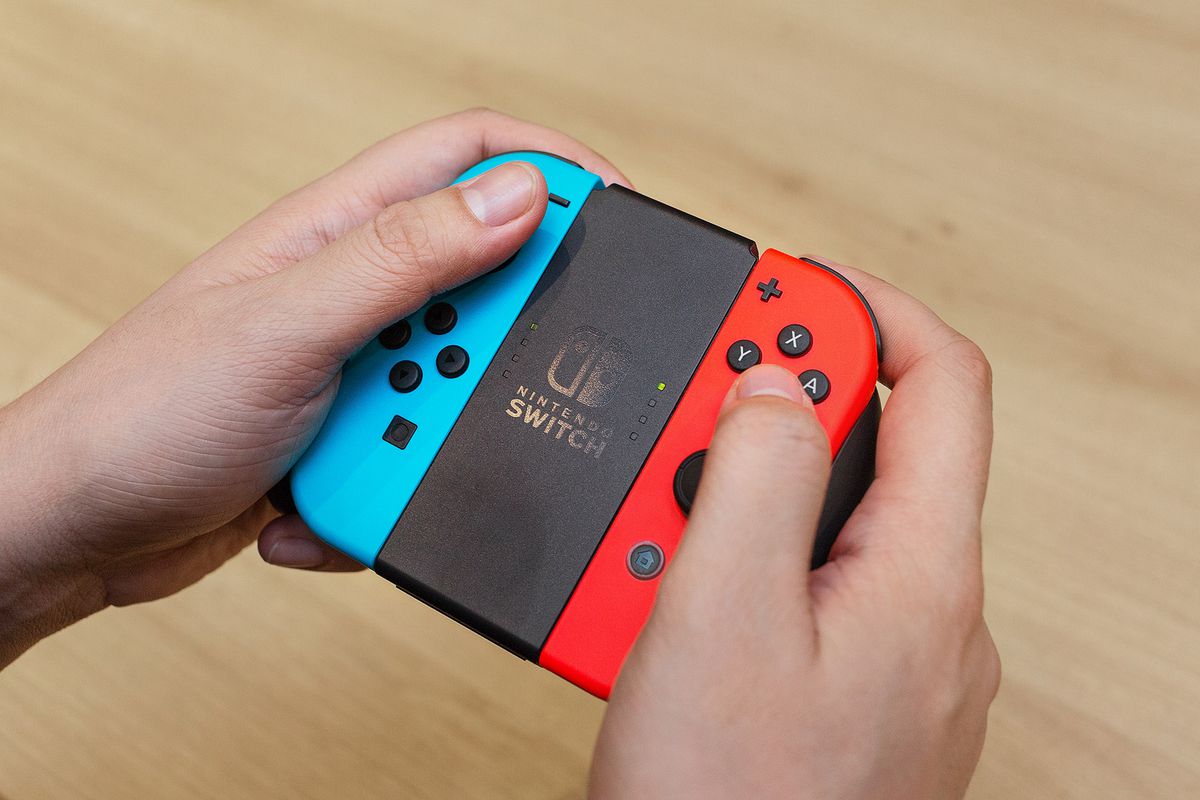 Nintendo Switch - blue and red Joy-Cons in Joy-Con Grip