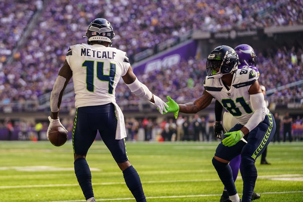 Seattle Seahawks wide receiver DK Metcalf (14) celebrates with his touchdown with tight end Gerald Everett (81) during the first quarter against Minnesota Vikings at U.S. Bank Stadium.