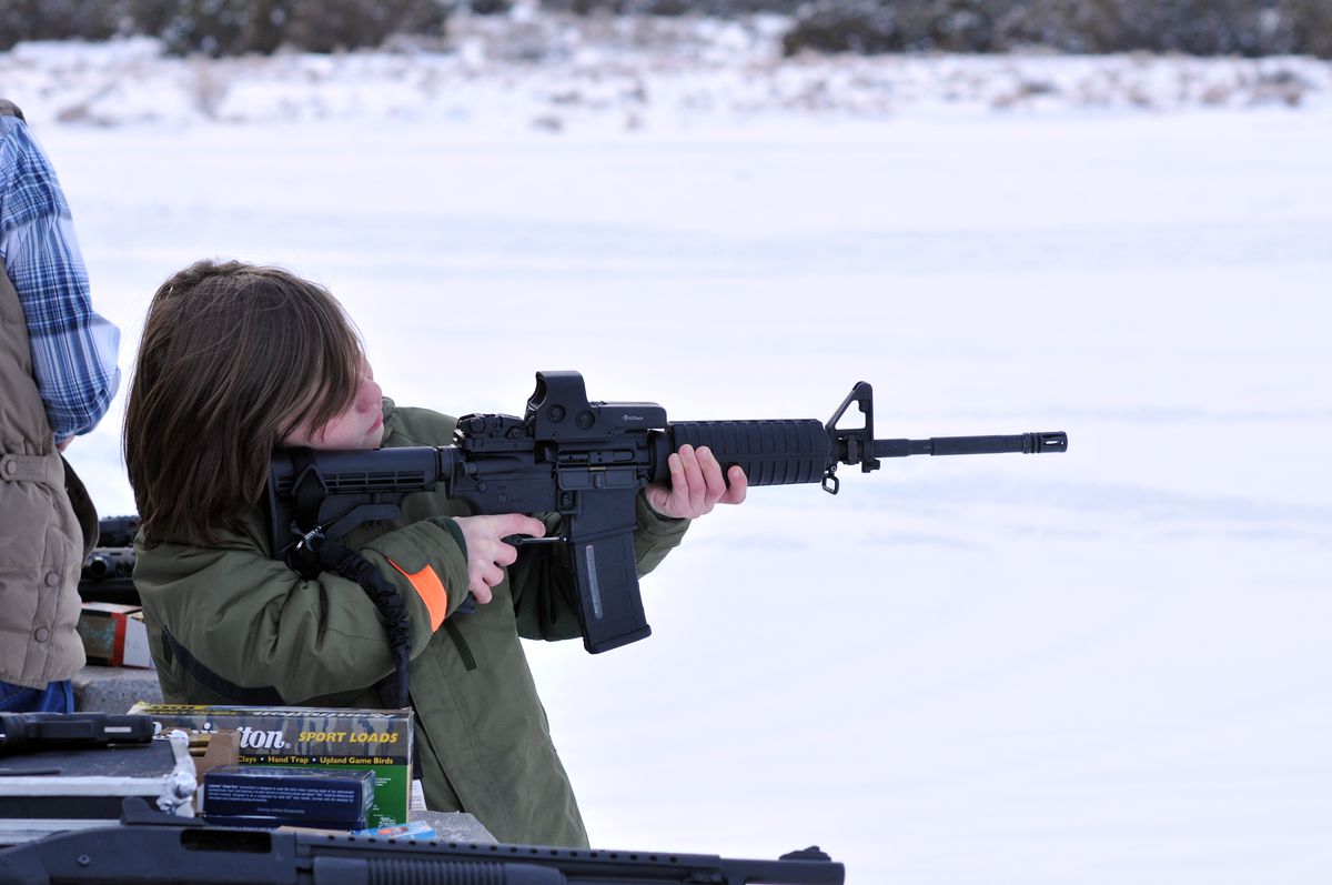 A child with an AR-15 rifle.