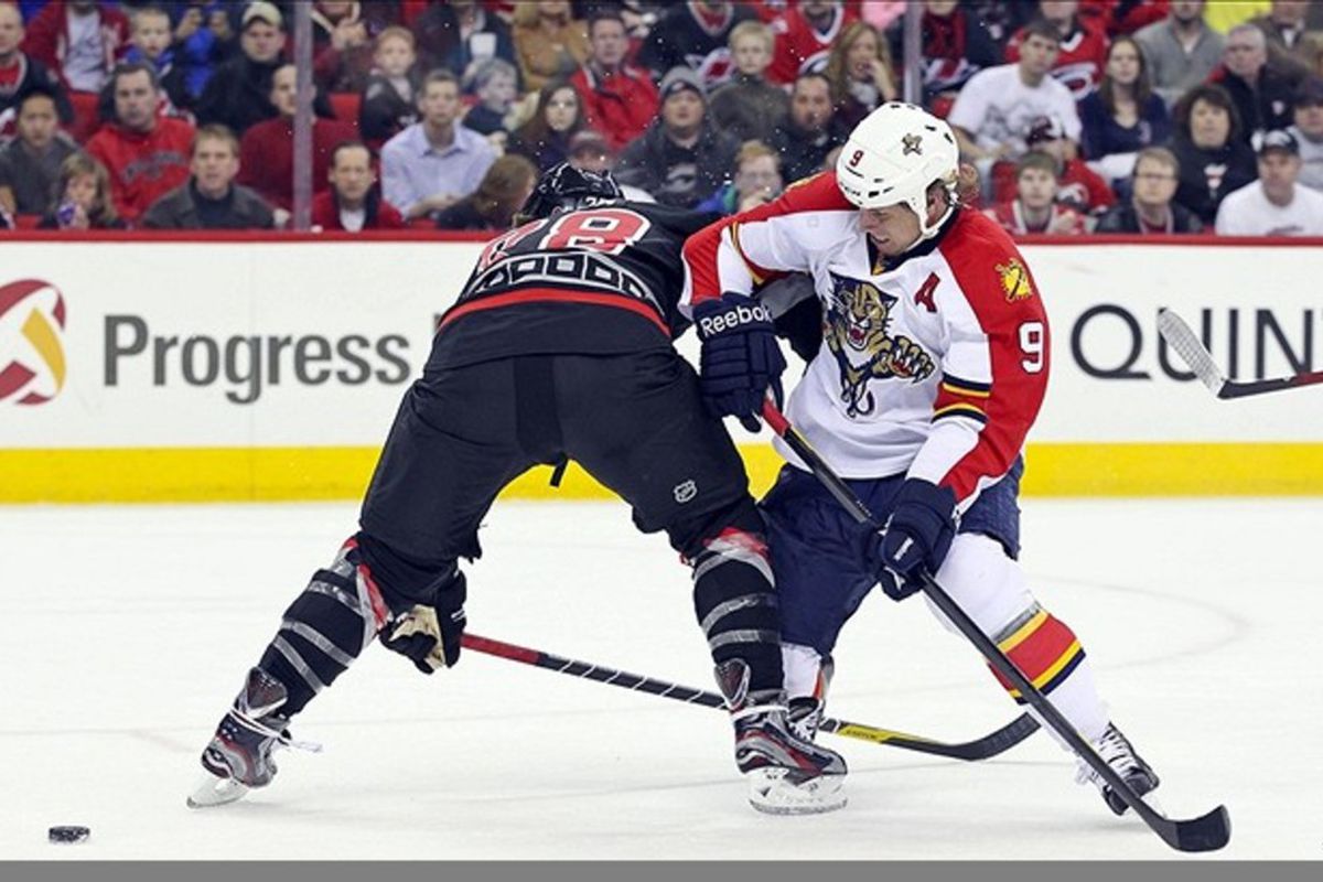 February 25, 2012; Raleigh, NC, USA; Carolina Hurricanes defensemen Justin Faulk (28) checks  Florida Panthers center Stephen Weiss (9) off the puck during the 1st period at the RBC center. Mandatory Credit: James Guillory-US PRESSWIRE