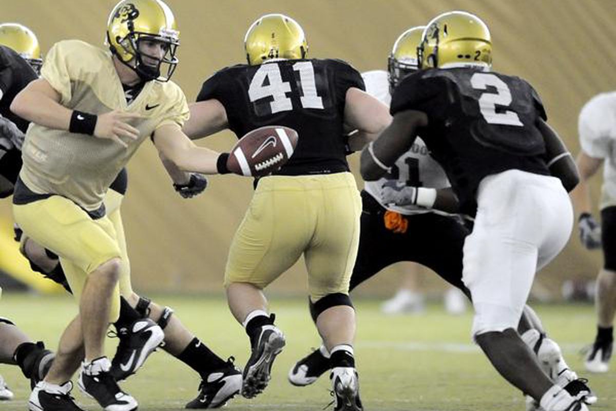 Colorado quarterback Cody Hawkins hands the ball off to Darrell Scott during their scimmage game in the practice dome at the University of Colorado in Boulder, Colorado April 17, 2009. CAMERA/Mark Leffingwell