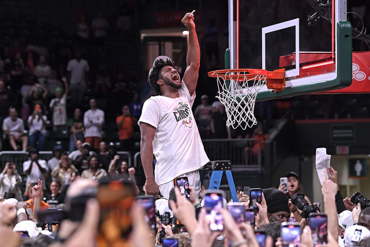 Miami forward Norchad Omier (15) cuts the net to celebrate Miami clinching a share of the ACC regular season championship after the Miami Hurricanes faced the Pittsburgh Panthers on March 4, 2023, at the Watsco Center in Coral Gables, Florida.