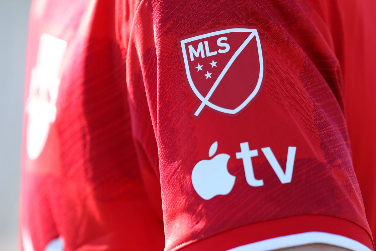 A&nbsp;detailed general view of the MLS logo on the red sleeve of a New York Red Bulls player along with the Apple TV logo - Apple and Major League Soccer present all MLS matches around the world for 10 years, beginning in 2023 - during the MLS Pre-Season 2023 Coachella Valley Invitational match between Minnesota United FC v New York Red Bulls at Empire Polo Club on February 11, 2023 in Indio, California.