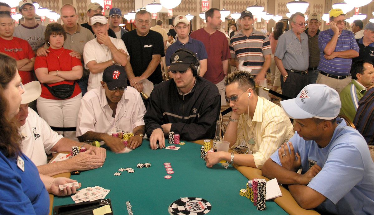 Phil Hellmuth, center, and Ivey, far right, compete in a tournament (Getty Images)