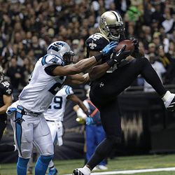 New Orleans Saints wide receiver Marques Colston (12) pulls in a touchdown reception over Carolina Panthers free safety Mike Mitchell (21) in the first half of an NFL football game in New Orleans, Sunday, Dec. 8, 2013.  (AP Photo/Dave Martin)