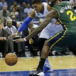 Orlando Magic small forward Tobias Harris, left, and Utah Jazz's Marvin Williams (2) go after a loose ball during the first half of an NBA basketball game in Orlando, Fla., Wednesday, Dec. 18, 2013. (AP Photo/John Raoux)