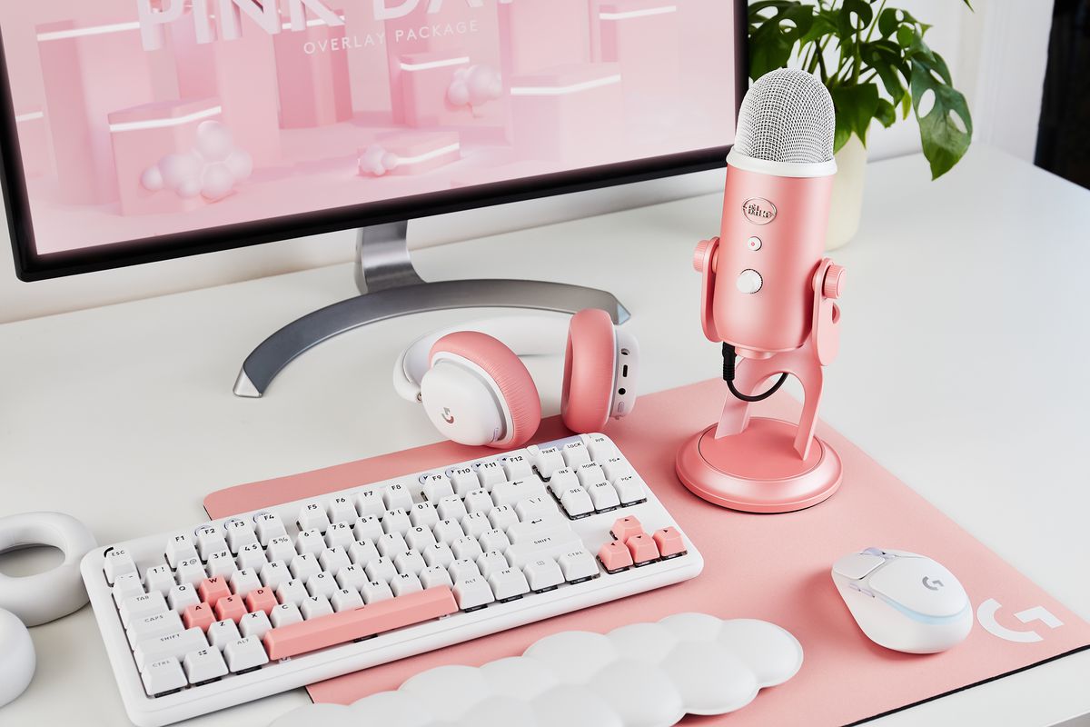 a pale pink gaming set up, complete with a cloud-shaped wrist pad