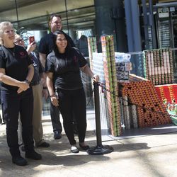 University of Utah Health employees stand next to a sculpture of the U.'s Rice-Eccles Stadium made out of healthy canned, bagged and boxed food at the Salt Lake Main Library on Thursday, Aug. 10, 2017. Teams from six local health care-related businesses built the sculptures for a community display and food drive sponsored by the Salt Lake County Health Department and the Salt Lake City Public Library System. The teams will donate all food used in their sculptures to the Utah Food Bank.