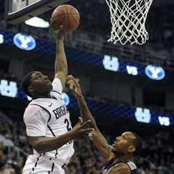 Brigham Young Cougars guard Frank Bartley IV (24) goes for a basket as Utah State Aggies center Jarred Shaw (5) defends during a game at EnergySolutions Arena on Saturday, November 30, 2013.