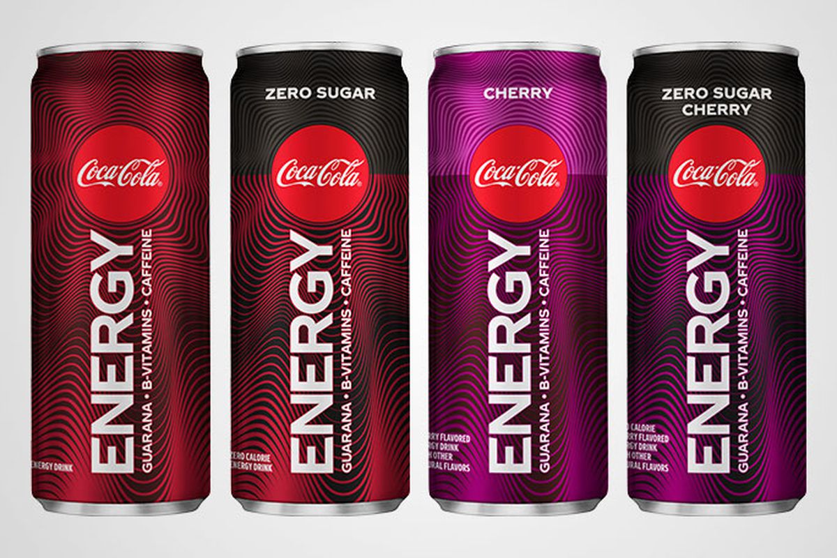 Four Coke Energy cans on a gray background.