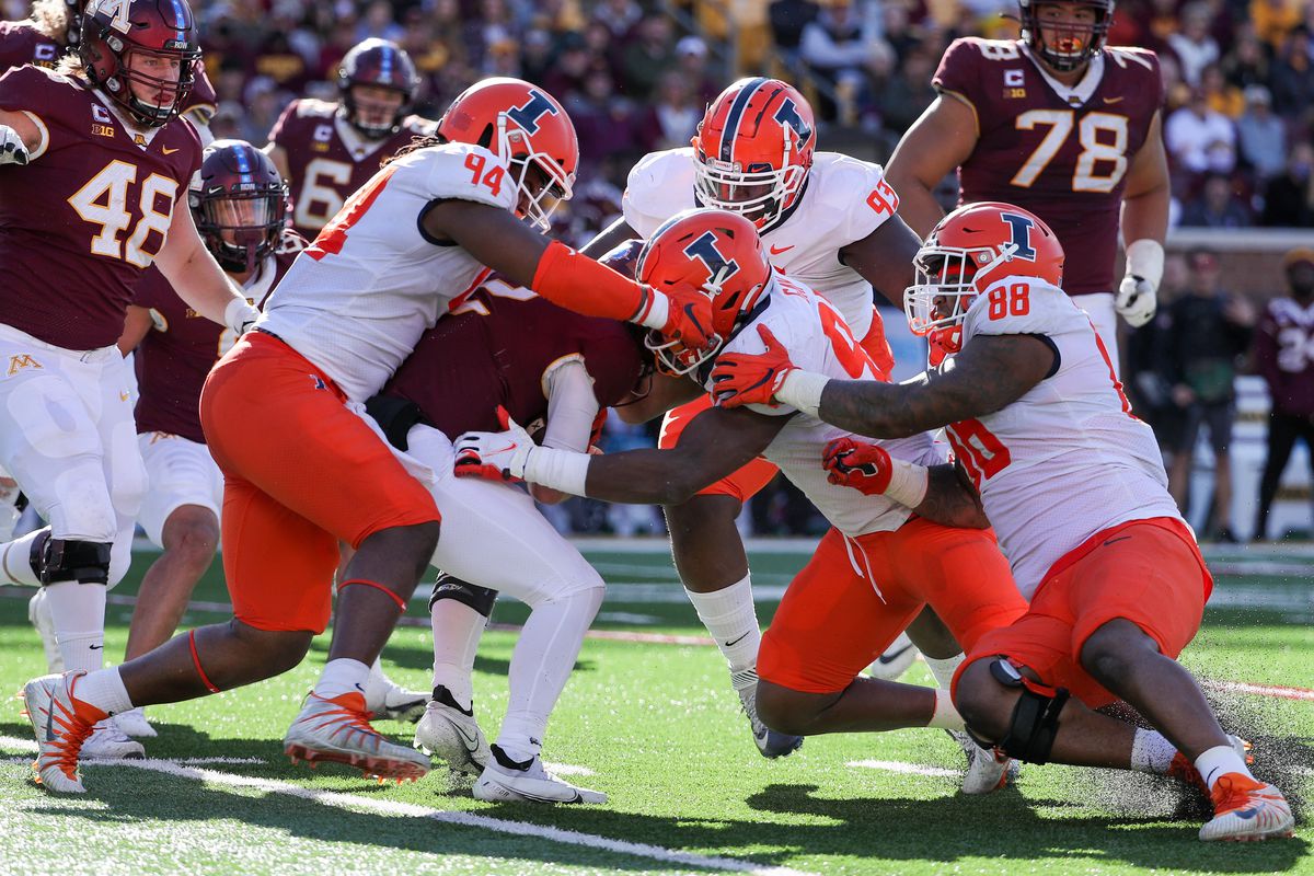 Nov 6, 2021; Minneapolis, Minnesota, USA; Minnesota Golden Gophers quarterback Tanner Morgan (2) is brought down by Illinois Fighting Illini defensive lineman Jer’Zhan Newton (94) and linebacker Isaiah Gay (92) for a loss in the fourth quarter at Huntington Bank Stadium.