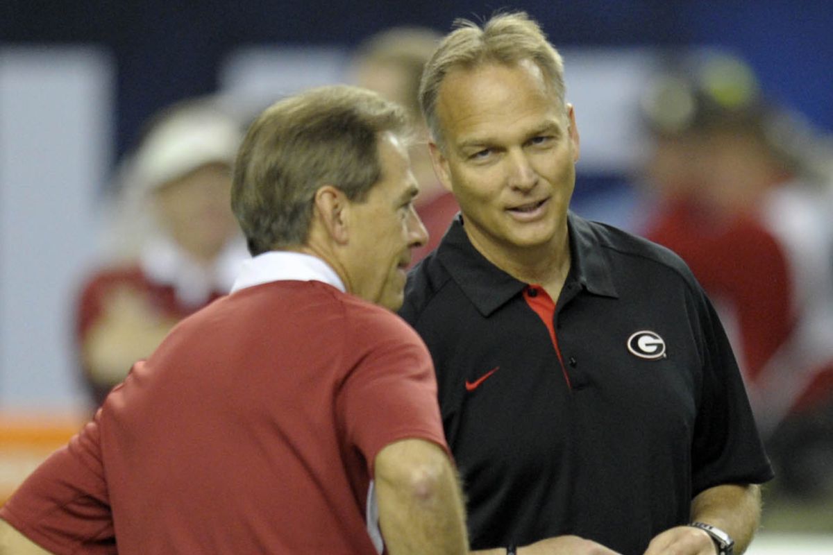 The architect of the most invincible dynastic juggernaut in college football history (left) spoke to the mediocre beneficiary of a weak schedule who lacks killer instinct (right) before their 11-1 teams played a game decided on the final snap.