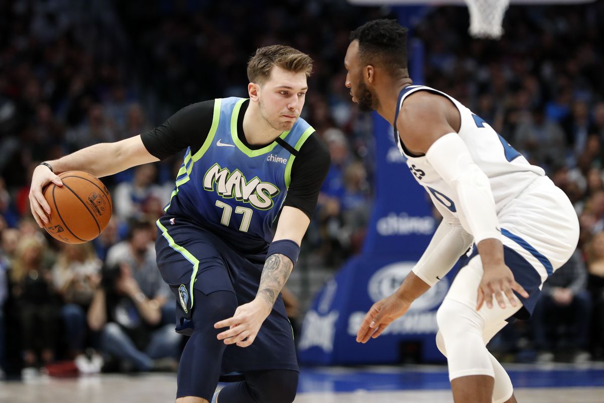 Dallas Mavericks guard Luka Doncic dribbles as Minnesota Timberwolves guard Josh Okogie defends during the second quarter at American Airlines Center.