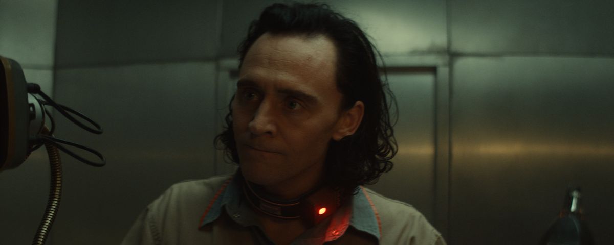 Loki furiously signs paperwork in the first episode of Loki