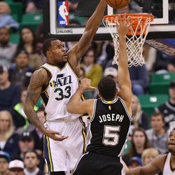 Utah Jazz forward Trevor Booker (33) blocks San Antonio Spurs guard Cory Joseph (5) as the Utah Jazz defeat the San Antonio Spurs 90-81 in NBA basketball Monday, Feb. 23, 2015, in Salt Lake City.  
