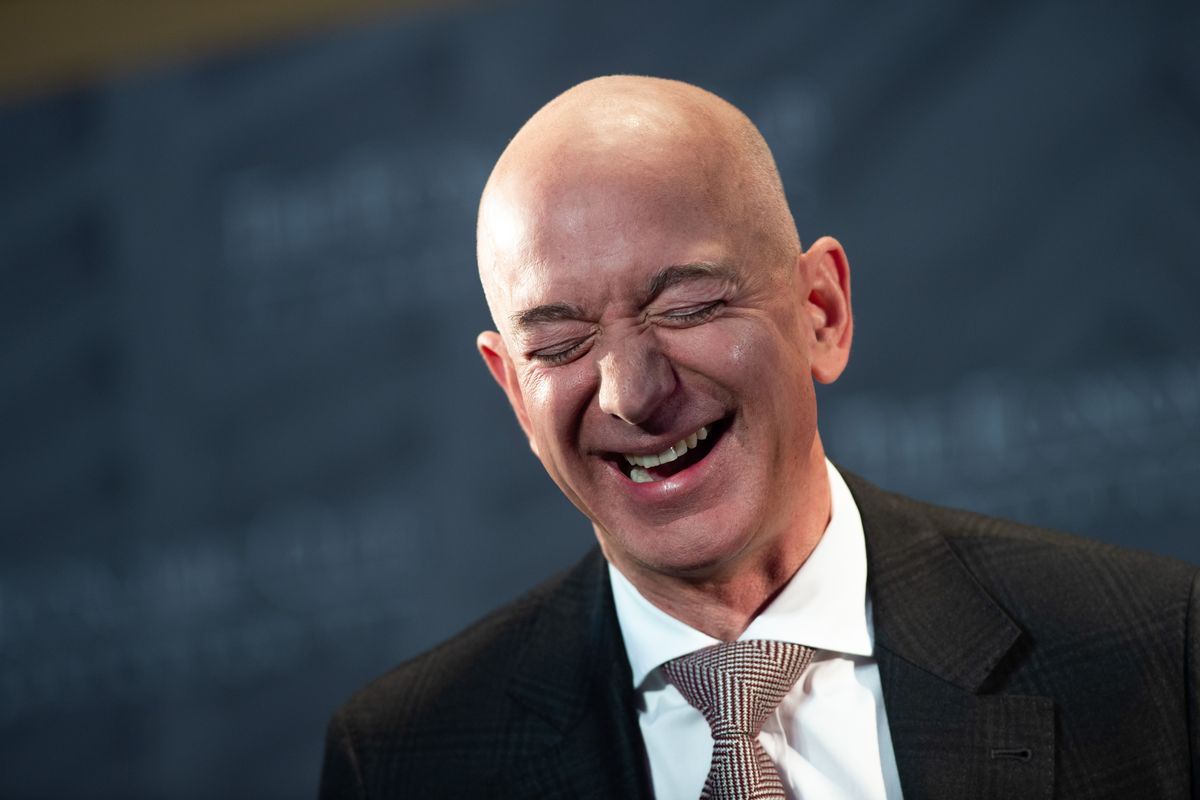 Amazon CEO Jeff Bezos smiles in a painful way.
