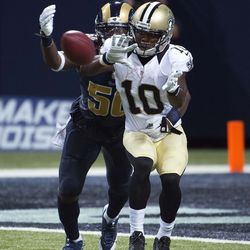 Aug 8, 2014; St. Louis, MO, USA; New Orleans Saints wide receiver Brandin Cooks (10) makes a catch as St. Louis Rams linebacker Ray-Ray Armstrong (50) defends at Edward Jones Dome. Mandatory Credit: Scott Rovak-USA TODAY Sports