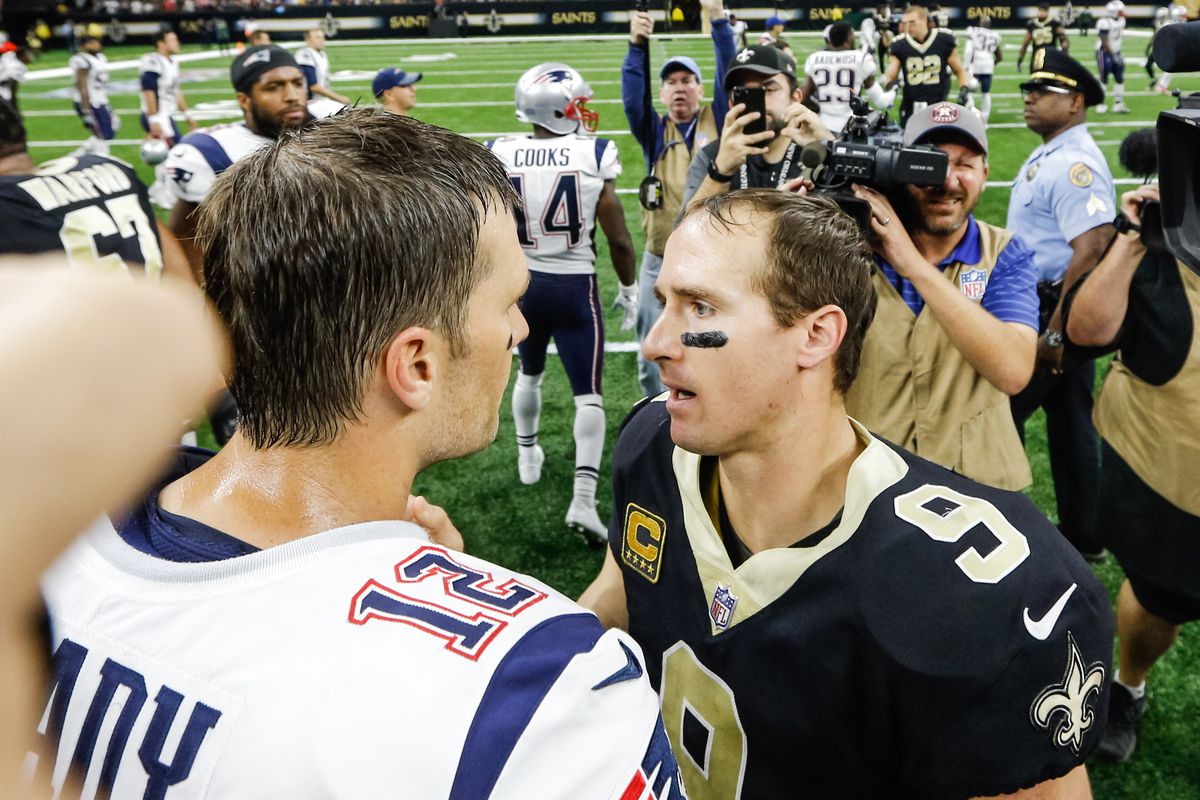New Orleans Saints quarterback Drew Brees talks to New England Patriots quarterback Tom Brady following a game at the Mercedes-Benz Superdome.