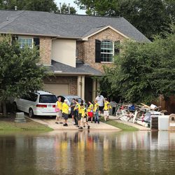 Mormon Helping Hand volunteers clean up a home in Klein, Texas, on Wednesday, Aug. 30, 2017, following Tropical Storm Harvey.