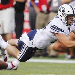 Brigham Young Cougars quarterback Tanner Magnum (12) dives for extra yardage against Nebraska in Lincoln, NE Saturday, Sept. 5, 2015. BYU won 33-28.