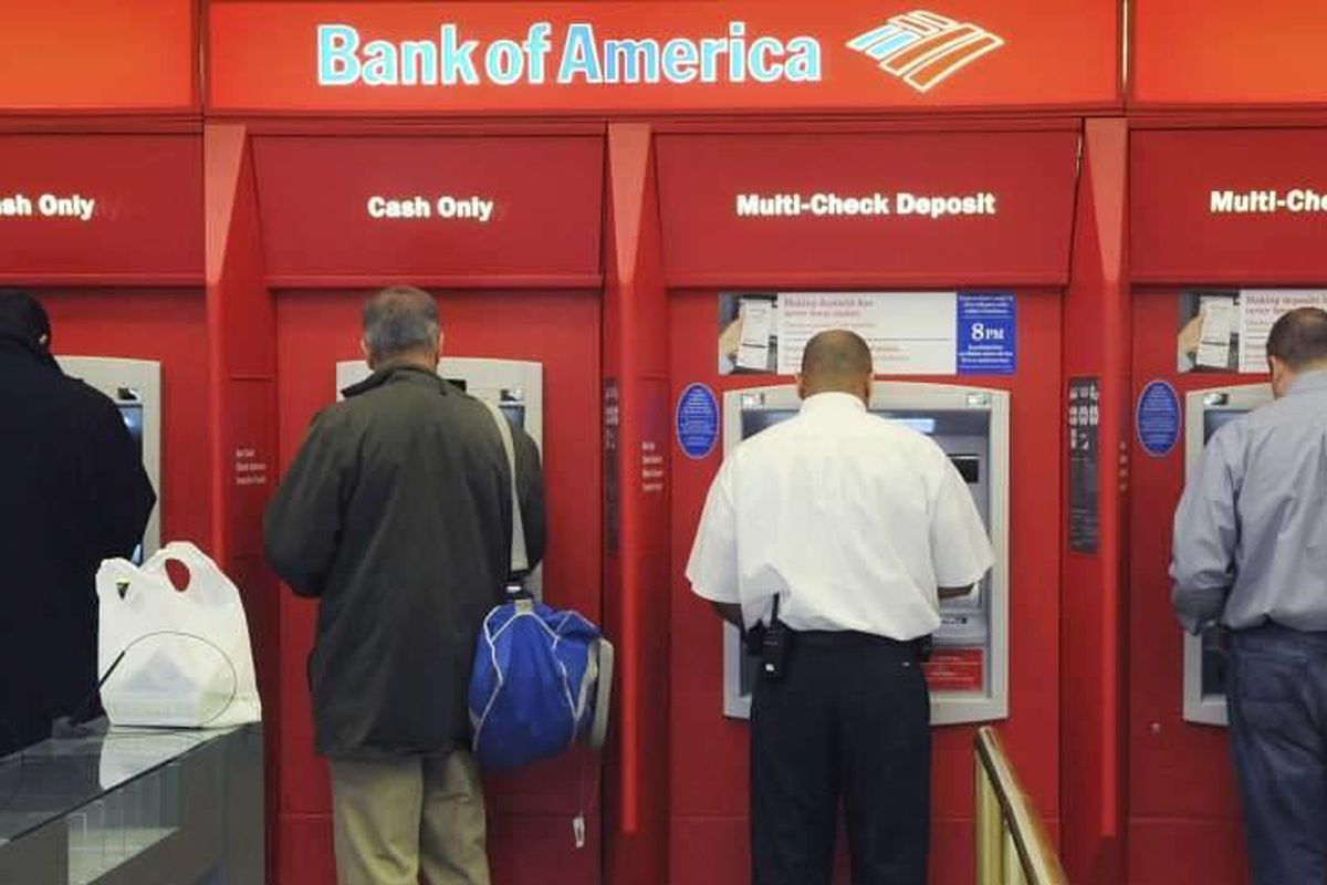 Customers use ATMs at a Bank of America branch office, Friday, Oct 16, 2009 in Boston. The Federal Reserve issued a rule that prohibited banks from charging overdraft fees on ATM and debit card transactions unless a customer allows it. In March 2013, a ne