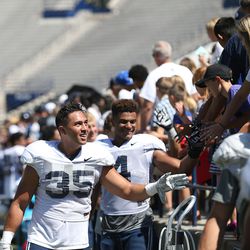 BYU's Va'a Niumatalolo, left, greets fans after a scrimmage at BYU in Provo on Saturday, Aug. 15, 2015.  