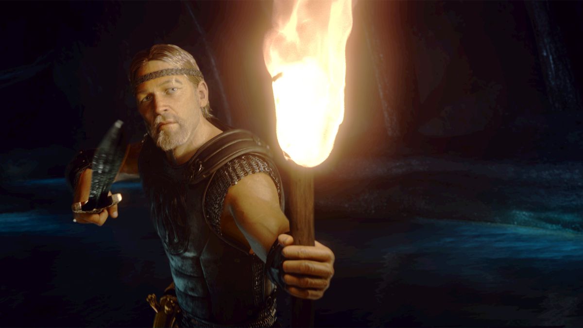 An man with a headband and dressed in nordic armor holds a sword and flaming torch with his back to a cavernous body of water.