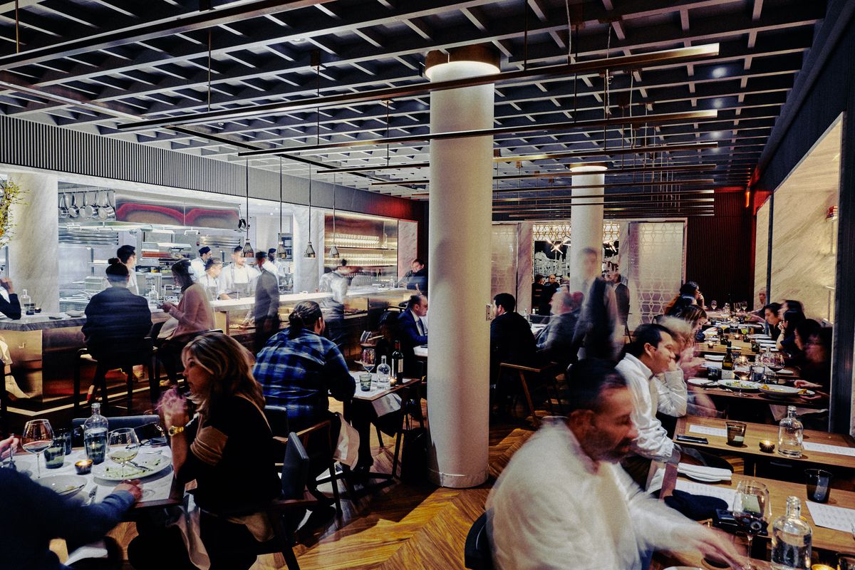 Customers seated throughout the busy indoor dining room at Intersect by Lexus.