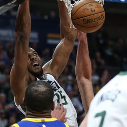 Utah Jazz forward Derrick Favors (15) dunks during the game against the Golden State Warriors at Vivint Arena in Salt Lake City on Tuesday, April 10, 2018.