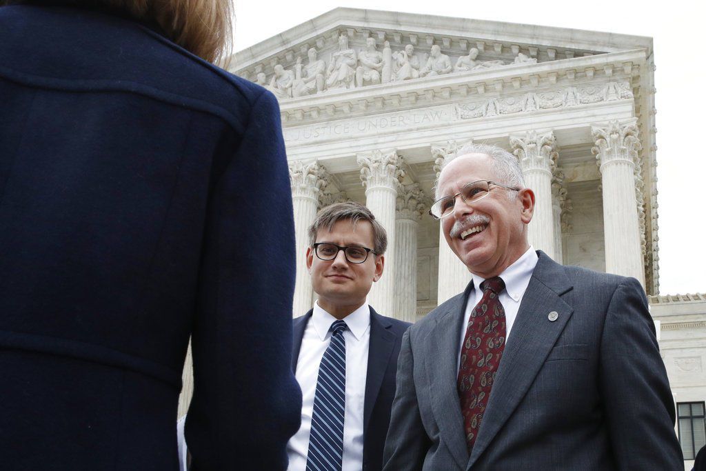 Illinois government employee Mark Janus, right, speaks with his legal team outside the Supreme Court, Monday, Feb. 26, 2018, in Washington. | AP Photo/Jacquelyn Martin
