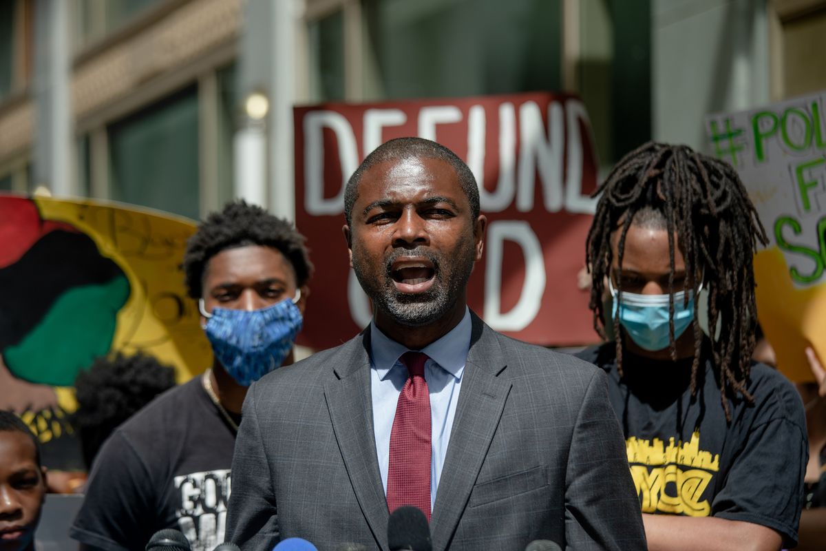 State Rep. La Shawn Ford joins a protest in June.